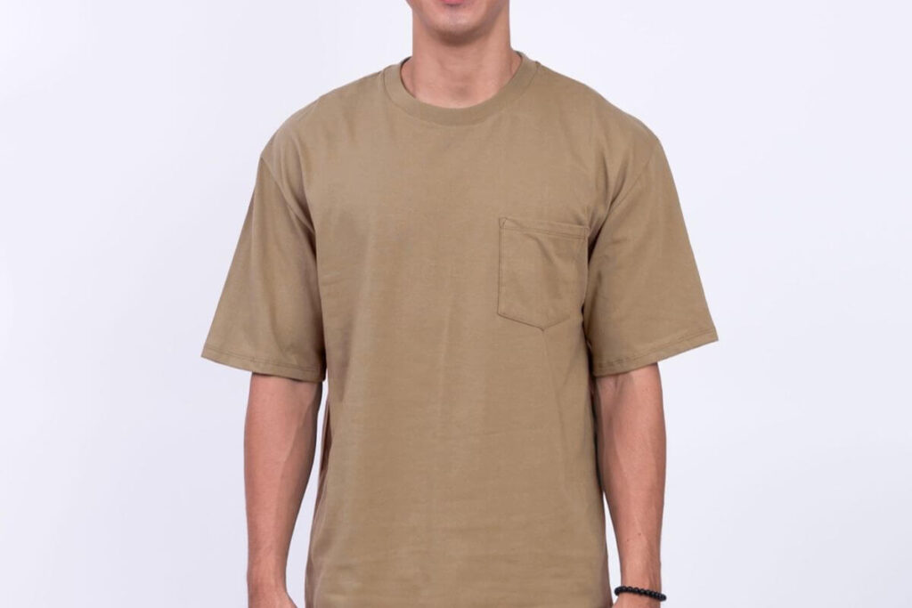 Male model wearing a khaki plain shirt with chest pocket