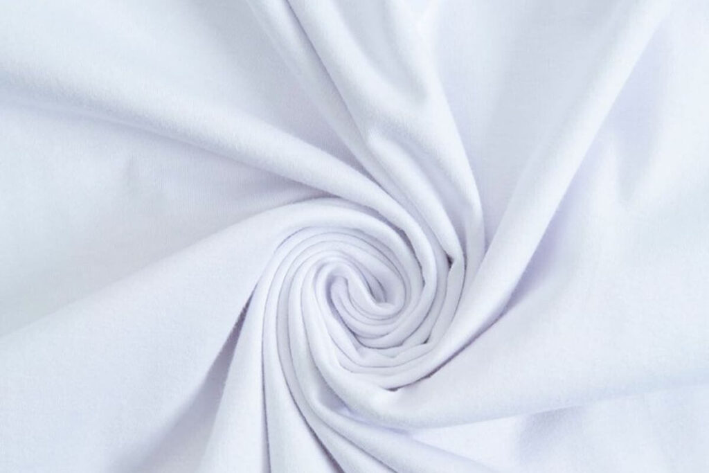 Close-up of soft white shirt fabric showing smooth cotton texture