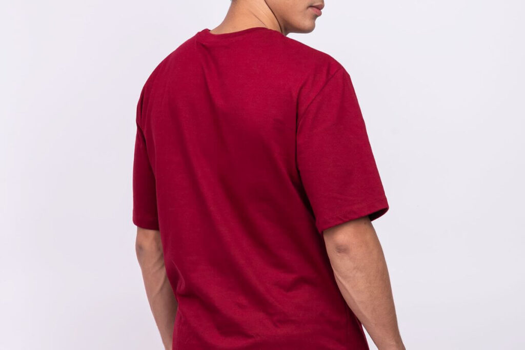Male model wearing a red oversized plain shirt showing relaxed fit and dropped shoulders