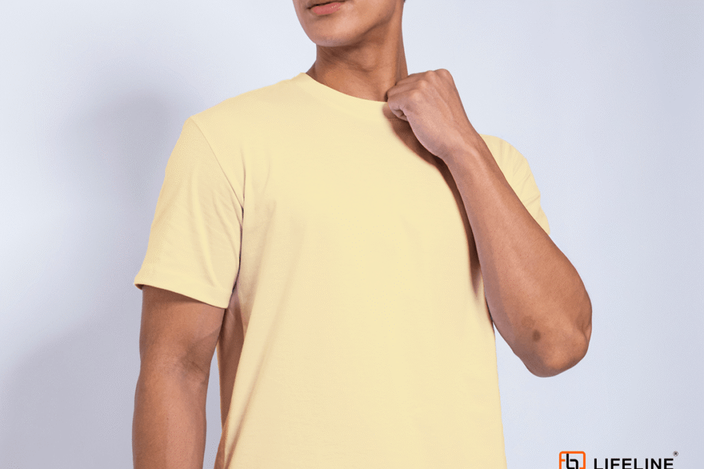 Male model wearing a pale yellow Lifeline plain round neck shirt with a clean neckline and comfortable fit